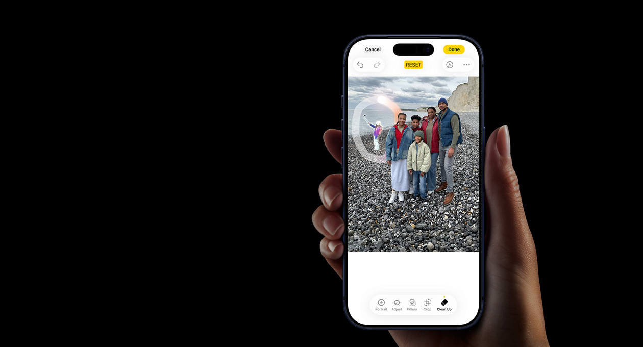 A hand holds an iPhone 17 Pro, demonstrating the Apple Intelligence Live Translation feature during a phone call with the speakerphone on.