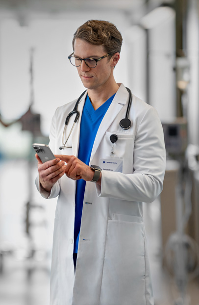 A provider’s wrist displaying an Apple Watch with a medication alert from the Epic app.